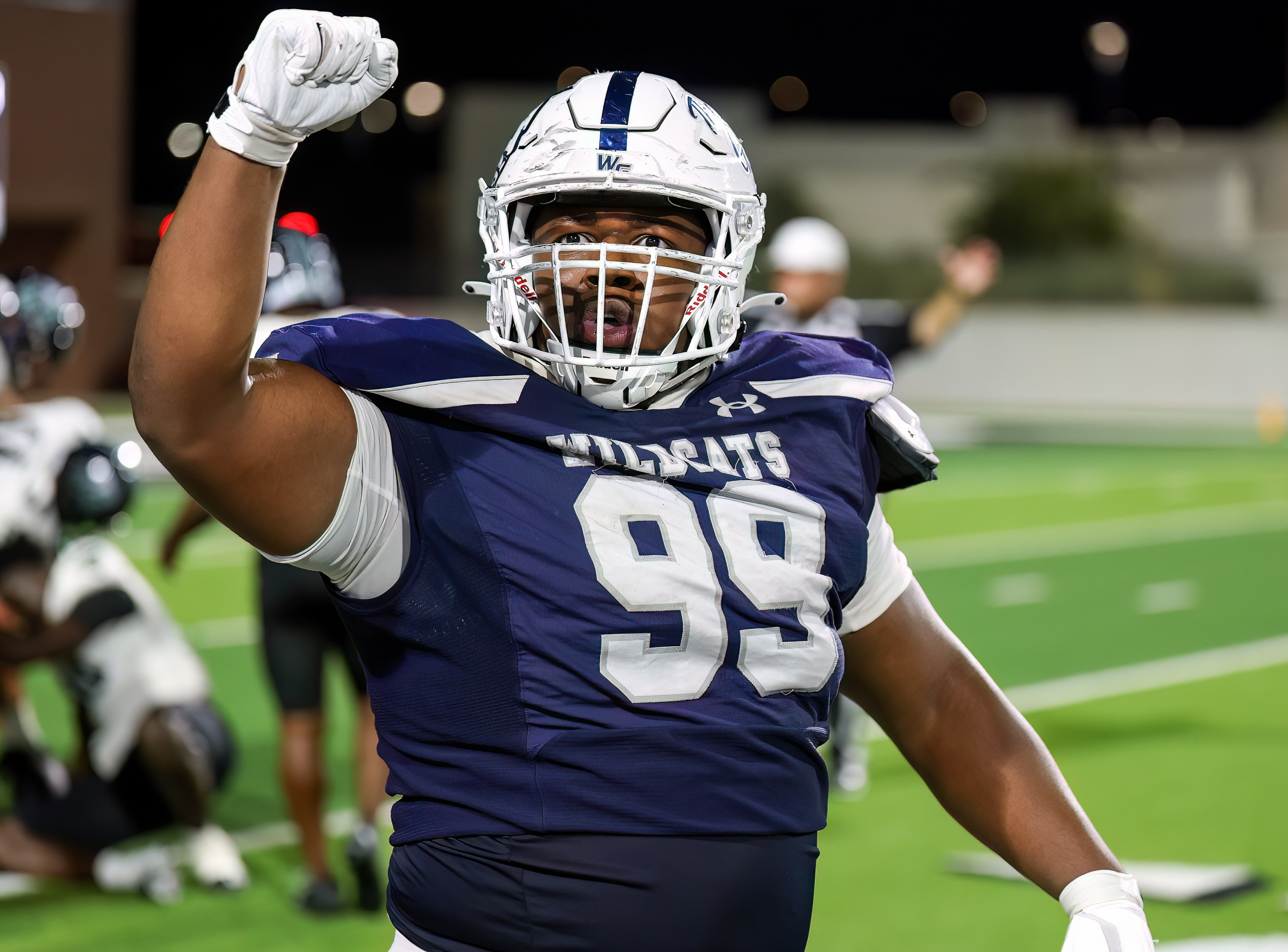 Kristopher Williams in his Walnut Grove number 99 jersey, raising a fist