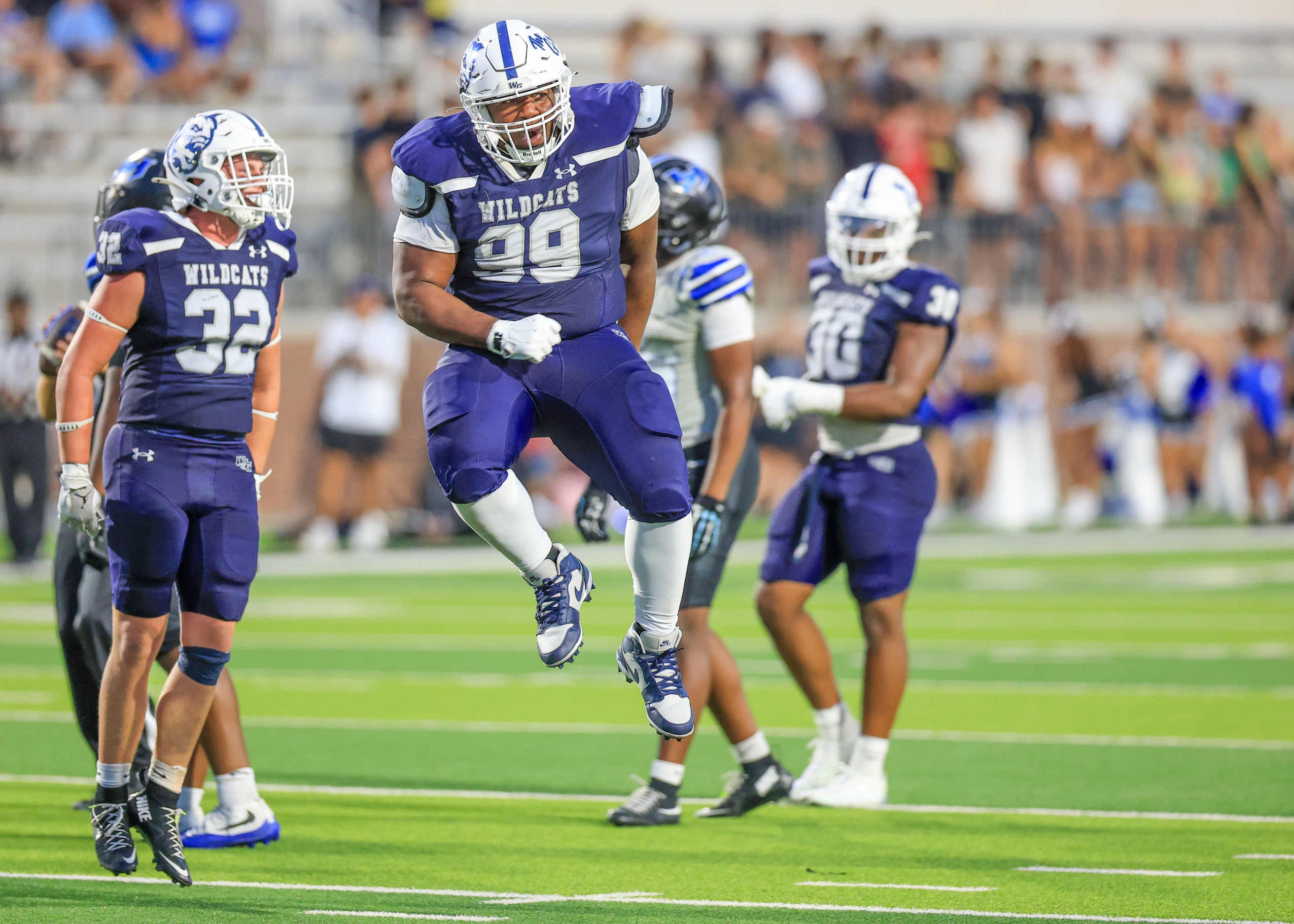 Kristopher Williams jumping to celebrate a play against Hebron