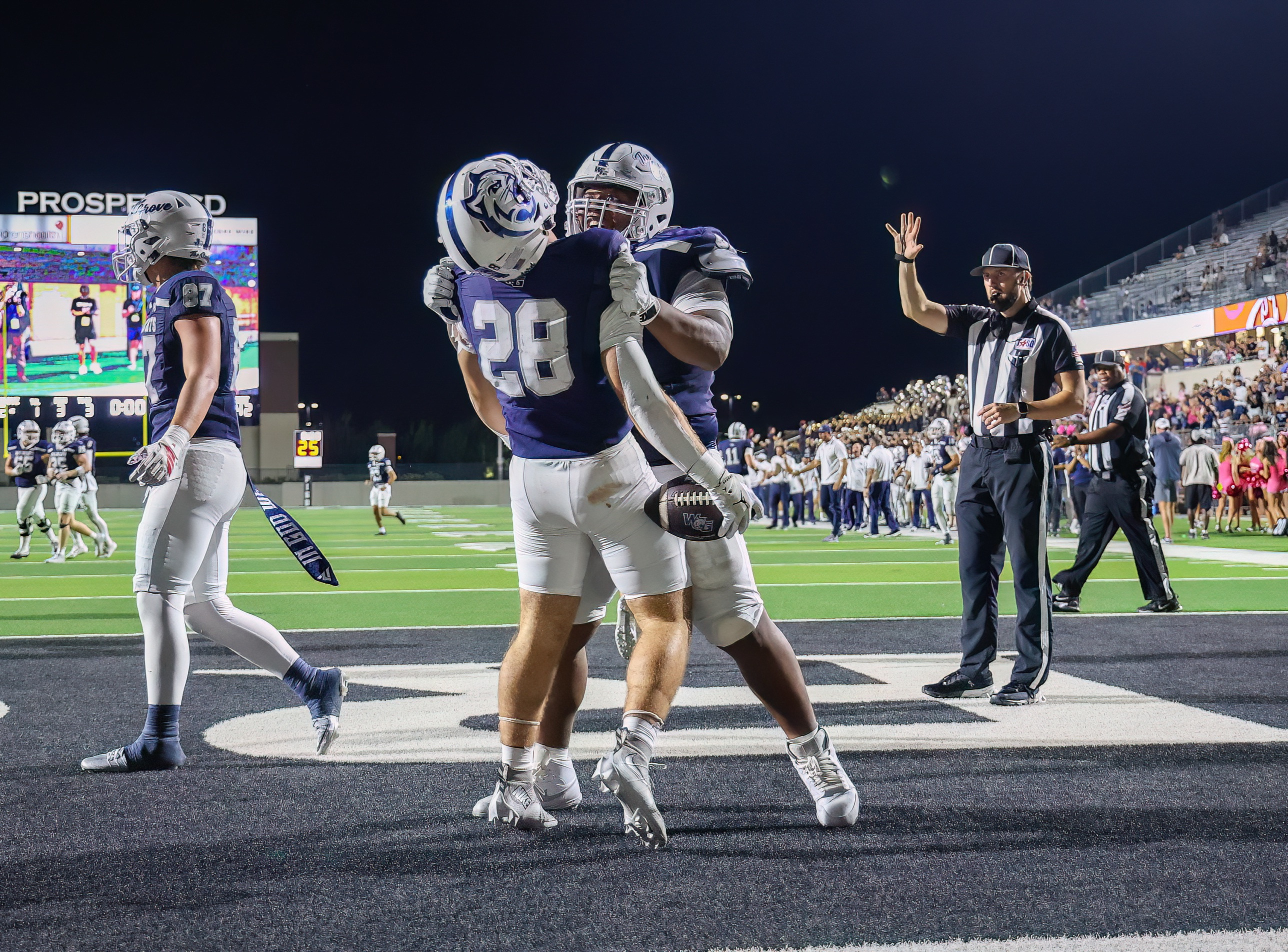 Kristopher Williams celebrating a touchdown with a teammate